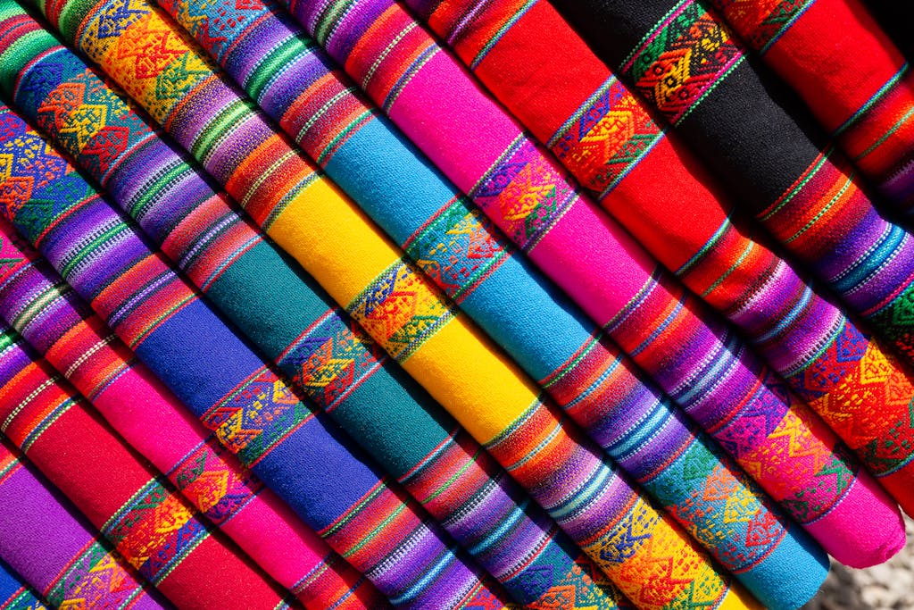 Colorful traditional woven fabrics with intricate patterns in vibrant hues.